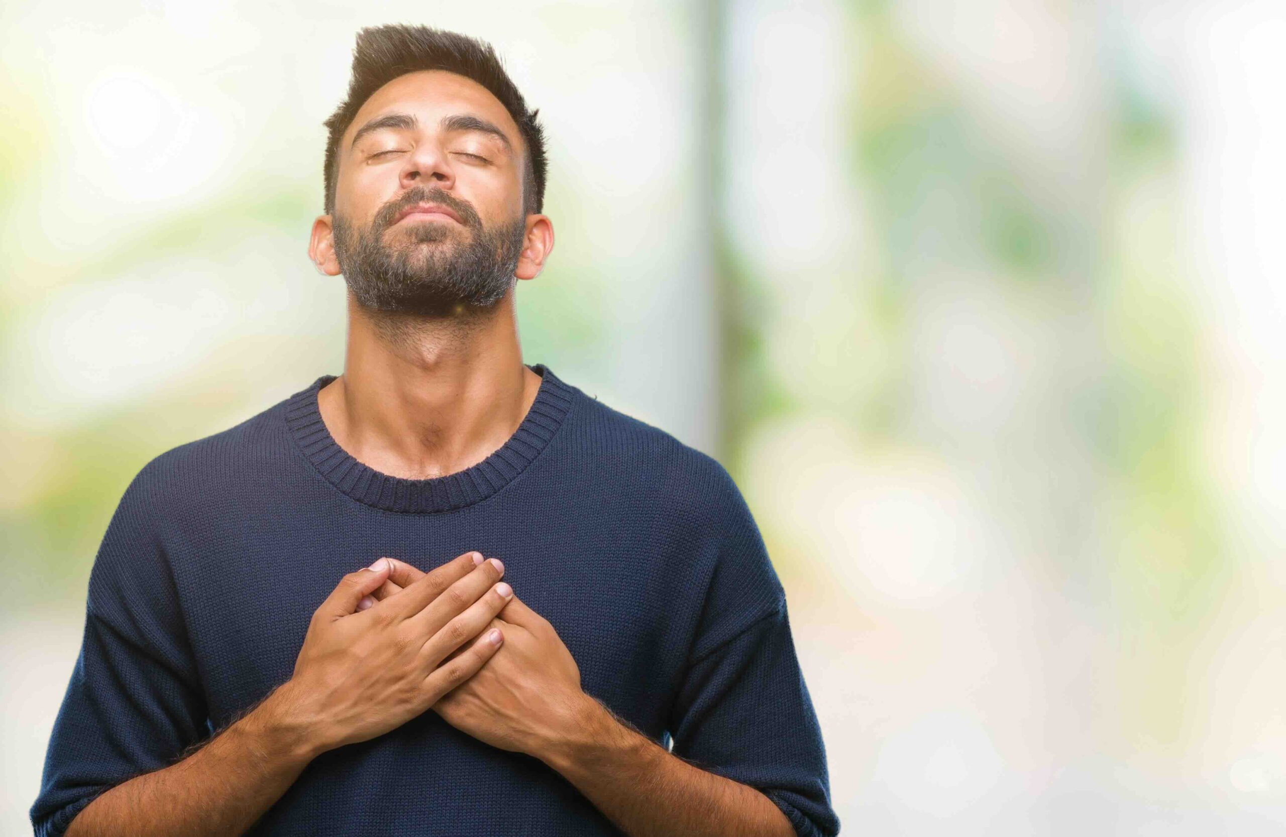 man grateful with his hands on his chest