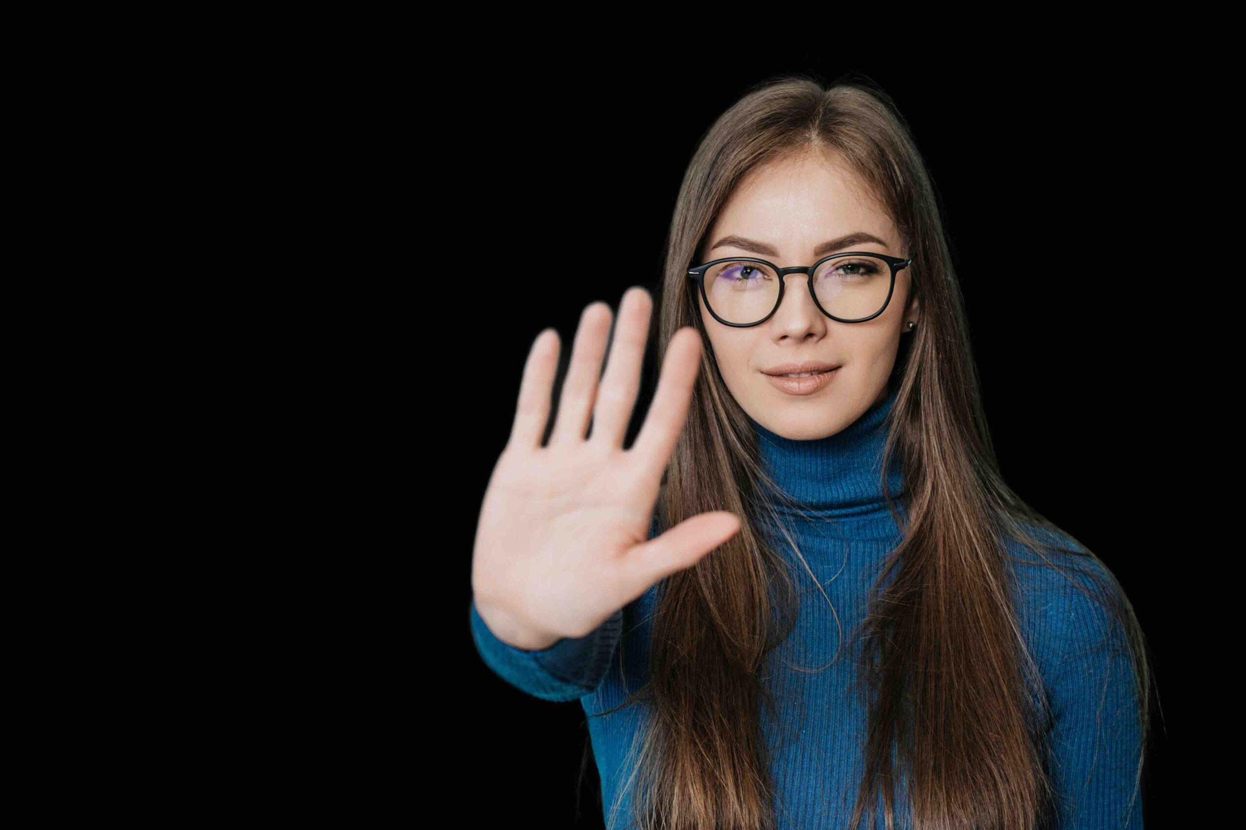 woman saying no with her hand in front of her